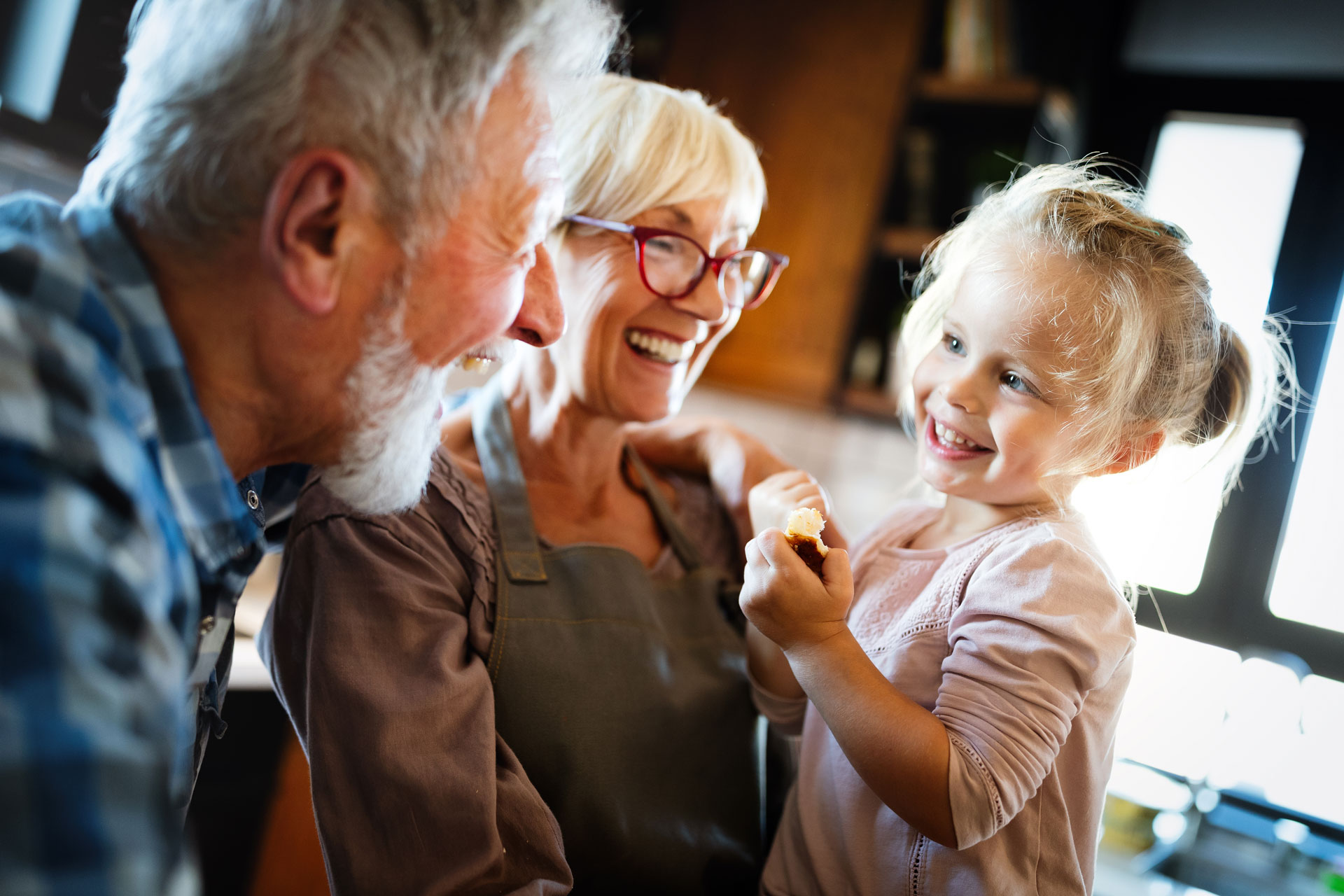 Older couple baking with granddaugher